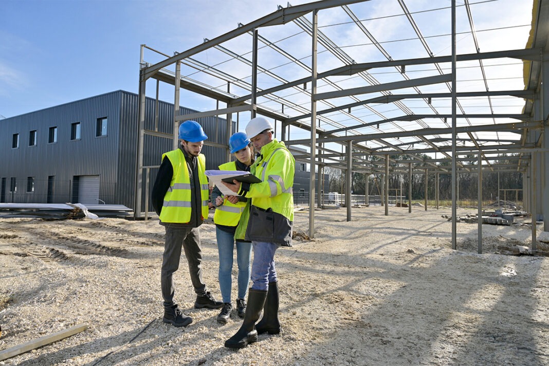 Engineering,Instructor,Working,On,Building,Site,With,Apprentice